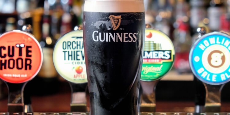 Diageo Faces Profit Slump and Tariff Blow Amid Leadership Crisis Published: 05 August '2025. The English Chronicle Desk Diageo, the world’s leading spirits producer and owner of iconic brands such as Guinness, Johnnie Walker, and Smirnoff, has reported a sharp 28% fall in its annual operating profits. This downturn has been attributed to a combination of internal challenges, shifting consumer habits, and external economic pressures—including a looming $200 million hit from new U.S. tariffs imposed under former President Donald Trump's trade policy. The company, listed on the FTSE 100, is also navigating a leadership transition following the sudden resignation of CEO Debra Crew. Crew’s departure, said to be by mutual agreement, came amid growing concern among investors over the company’s declining share price and overall performance. She had taken charge in 2023 after the unexpected death of long-serving and well-respected CEO Ivan Menezes. Under Crew, Diageo faced multiple setbacks, including sluggish sales in Latin America and supply chain issues that caused a Guinness shortage during last year’s holiday season. Interim CEO Nik Jhangiani, the company’s current CFO, has expanded Diageo’s cost-cutting initiative, increasing the savings target from £500 million to £625 million. While some roles are expected to be cut, Jhangiani emphasized that the overall workforce may still grow as part of a broader restructuring. Despite the challenging year, he pointed to strong performances from certain products such as Guinness, Don Julio tequila, and Crown Royal Blackberry as bright spots in an otherwise underwhelming fiscal report. Compounding its financial concerns, Diageo is bracing for a significant hit from newly enforced U.S. tariffs. The 10% levy on UK-imported spirits, along with a 15% tax on EU imports—while sparing Mexican and Canadian products—is expected to cost the company approximately $200 million annually. These tariffs took effect after the implementation of the UK-US trade agreement on 30 June, with additional EU tariffs set to begin on 7 August. In response, Diageo has ramped up contingency planning, aiming to counter the tariff effects through inventory management, supply chain adjustments, and the reallocation of investments. According to internal projections, these measures could offset up to half of the anticipated financial impact. Despite these efforts, Diageo’s stock has plummeted over 25% since the start of the year, placing it among the poorest performers on the FTSE 100 index. Analysts also point to broader market trends, such as shifting drinking habits among younger consumers and the ongoing cost-of-living crisis, as factors contributing to the public’s growing preference for more affordable, non-premium brands. With a new CEO yet to be named and economic headwinds continuing to buffet the global spirits industry, Diageo stands at a crossroads—needing to stabilize operations, restore investor confidence, and adapt to an evolving market landscape.