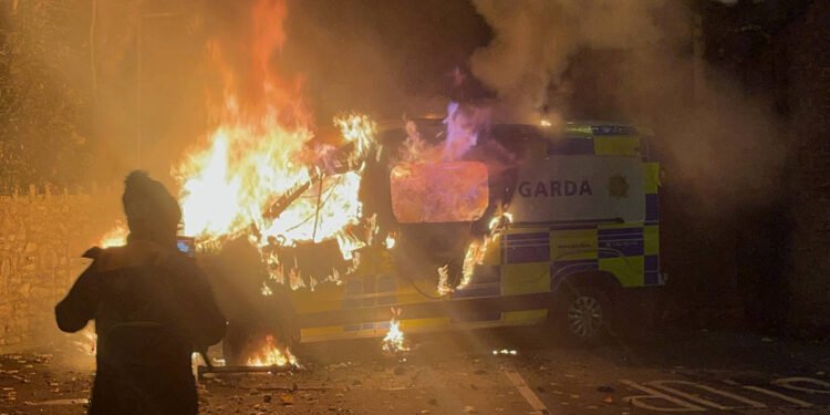 Violence erupts outside Dublin asylum hotel as police targeted