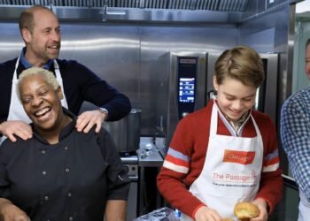 Prince George joins father Prince William in preparing Christmas lunch for homeless guests at The Passage.