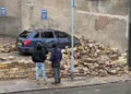 wall collapses on to car